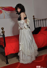 Excited crossdresser wearing a long wedding dress and