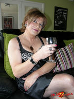Sexy sophisticated tranny sipping a glass of wine and