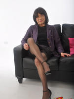 Hot tgirl looking like a sexy secretary posing on the sofa